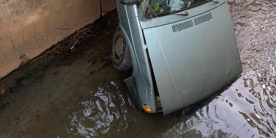 Carro caiu de uma altura aproximada de 3 metros dentro do canal de escoamento do Córrego das Almas com a parte da frente submersa pela água contaminada por esgoto (Divulgação / CBMMG)